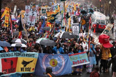 "Activists participate in a protest against the Dakota Access Pipeline March 10, 2017 in Washington, DC. Alex Wong / Getty Images" [1]